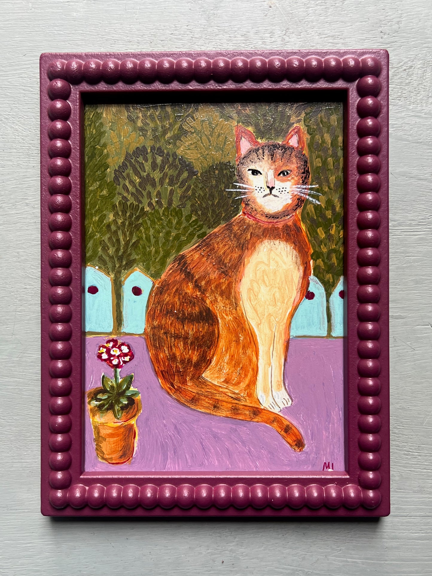 Original acrylic painting of a ginger cat sitting beside a potted flower against a leafy garden background, painted on a small wooden panel in folk art style.