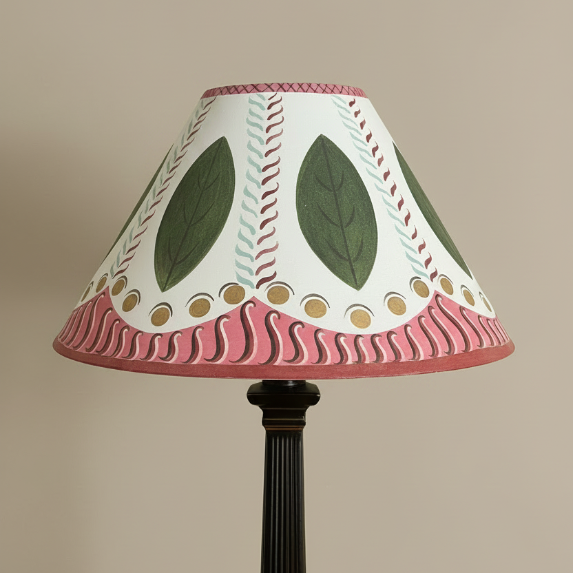 Decorative lamp with a leaf-patterned shade on a beige background