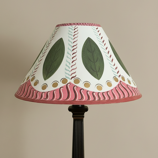 Decorative lamp with a leaf-patterned shade on a beige background