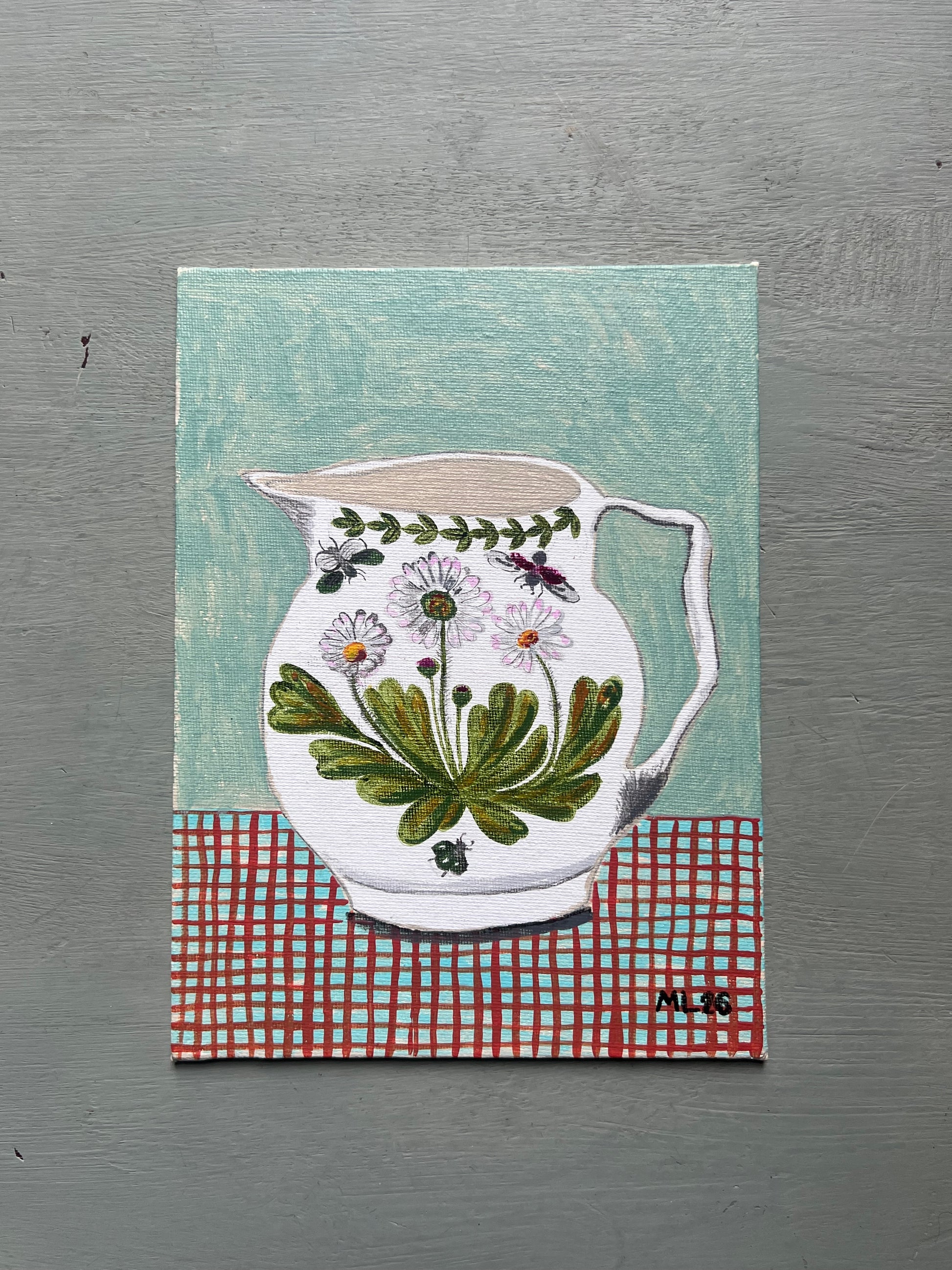 Original acrylic painting of a white jug decorated with daisies and beetles on a red checked surface against a pale aqua background, painted on 6 x 8 inch canvas board.