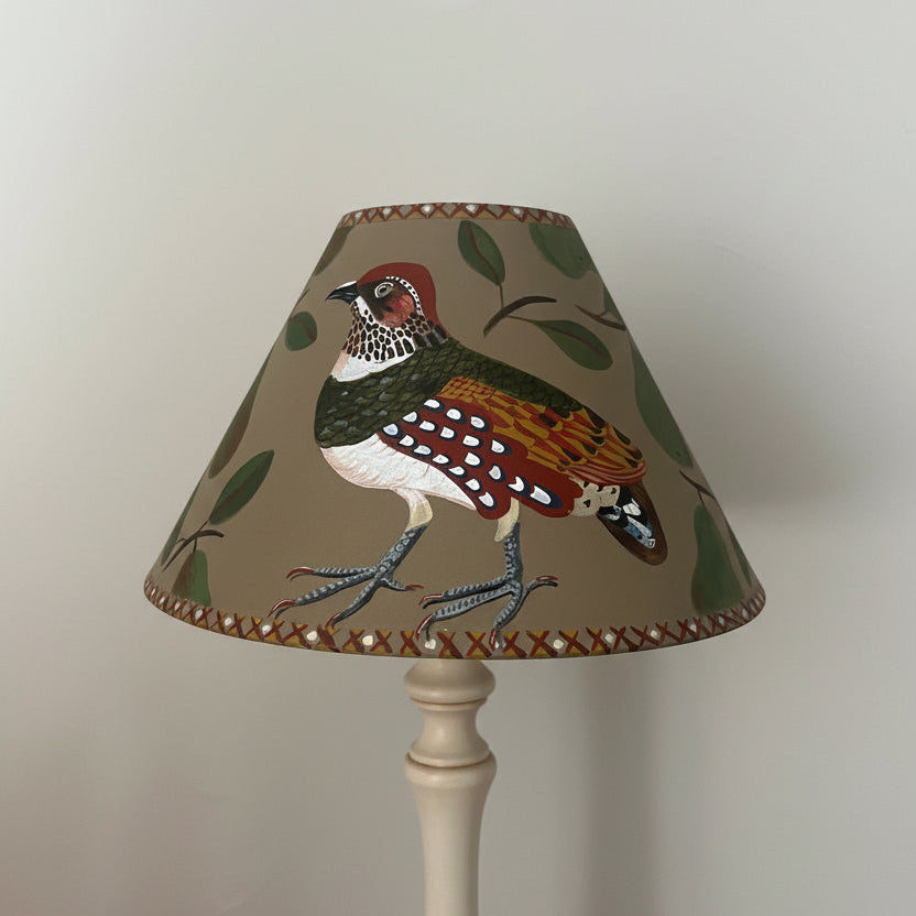 Decorative hand painted lampshade with a partridge design on a plain taupe 
background